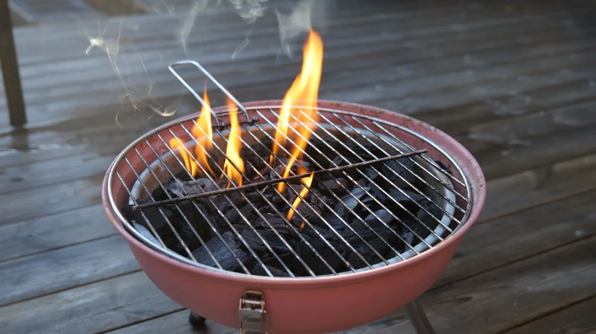 Charcoal fire heating a grill